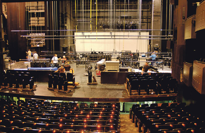 Technicians working on the get-out in a theatre. Photo: Shutterstock