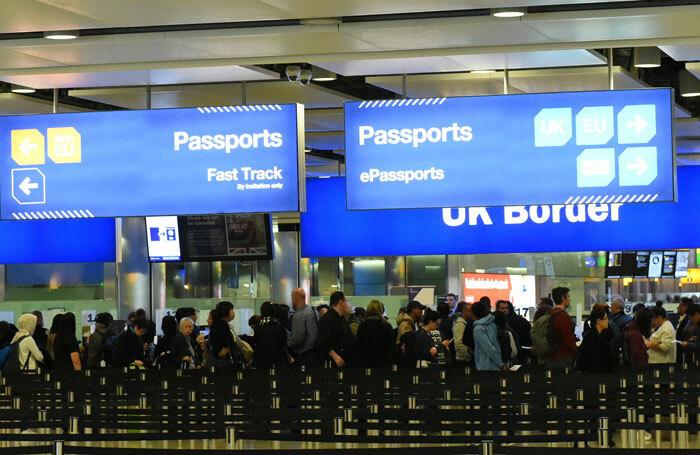 Airline passengers queue at border control at Heathrow Airport. Photo: Shutterstock