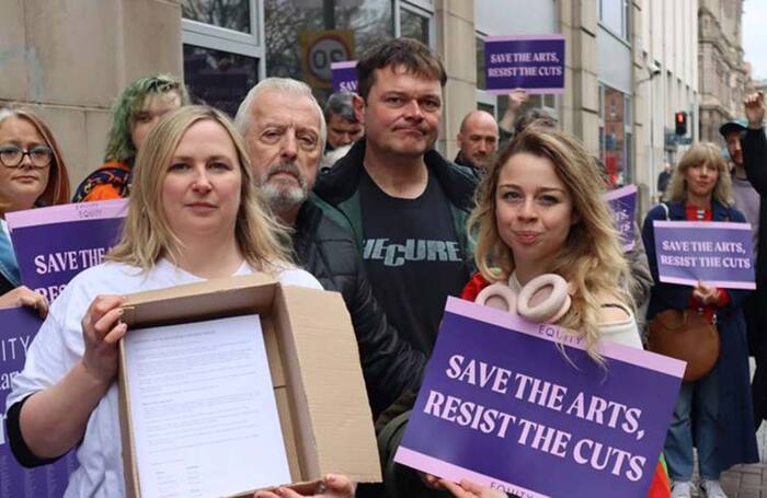 Supporters deliver Equity’s 11,000-plus Resist the Cuts petition to permanent secretary Colum Boyle, at the Department for Communities on April 27. Photo: Amanda Doherty