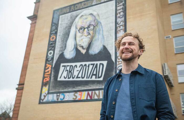 Gary McNair next to a mural of Billy Connolly in Glasgow. Photo: Tommy Ga-Ken Wan