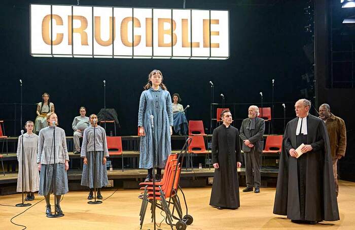 Millicent Wong (on chair) and the Company in The Crucible at the Crucible, Sheffield. Photo: Manuel Harlan.