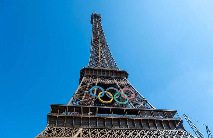 The Olympic rings logo hangs from the Eiffel Tower. Photo: Shutterstock