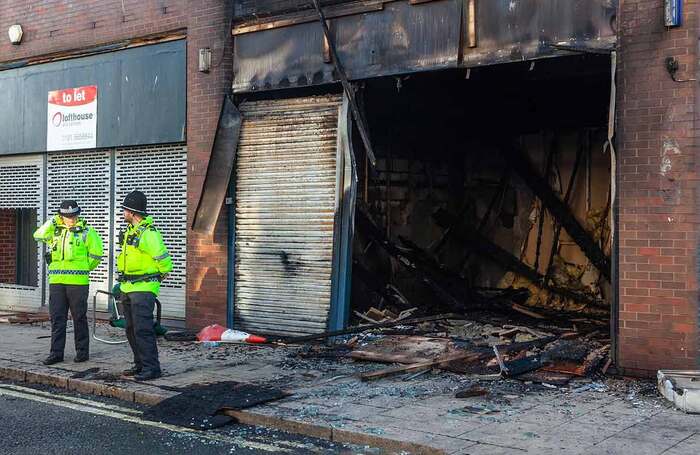 Police stand guard at the burned out Sunderland Citizens Advice Bureau following the far-right riots. Photo: Shutterstock