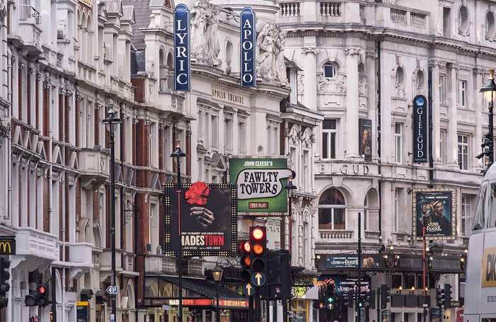 London's West End featuring historic theatre buildings with vibrant billboards (2024). Photo: Shutterstock